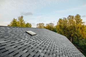 new renovated roof covered with shingles flat polymeric roof-til
